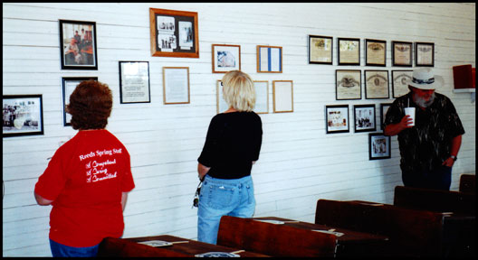 Visitors browse a wall of photos