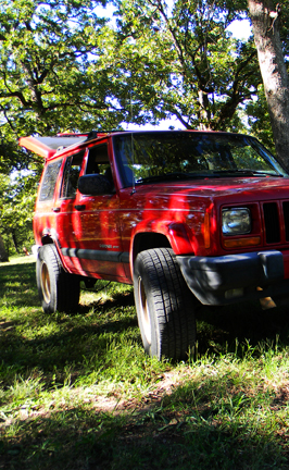 A classic red jeep, quintessential off-roading truck of the hills